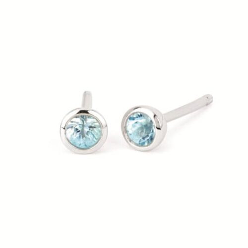 Silver stud earrings with round light-blue gemstones set in bezel settings, pairs shown side by side.